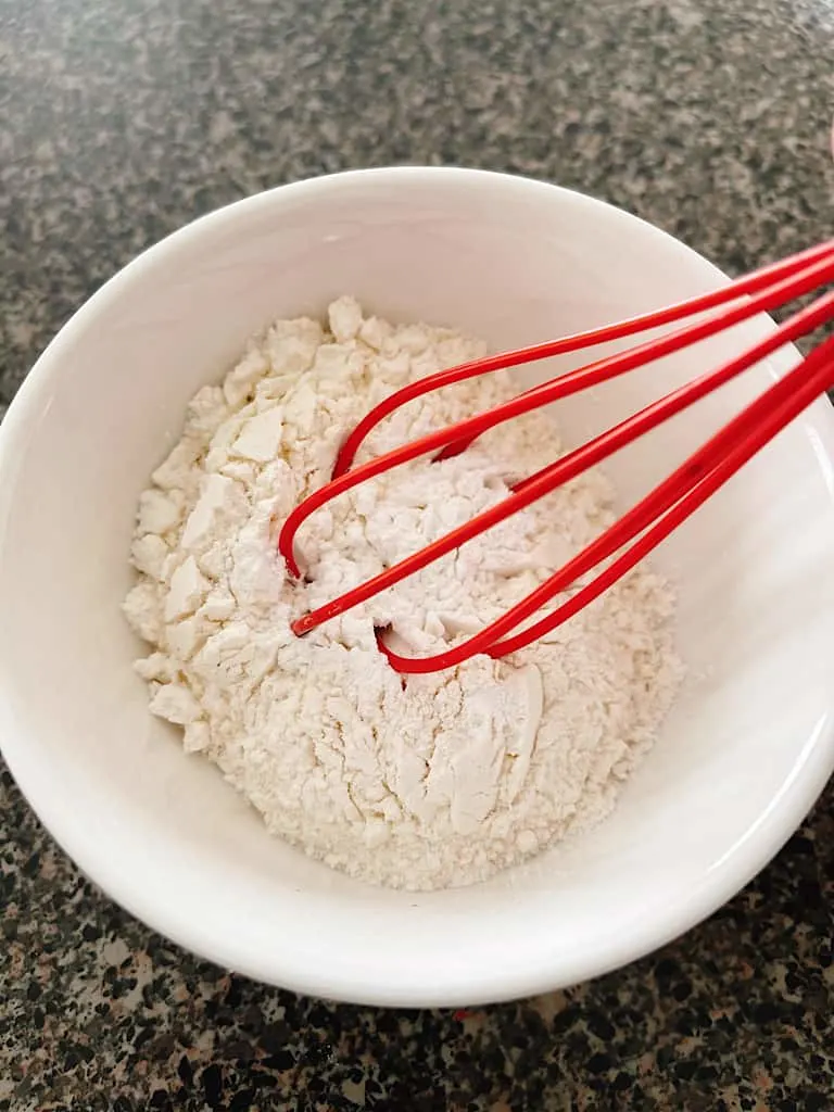 In a separate bowl, whisk together the flour and baking powder. Then mix into the chocolate mixture.