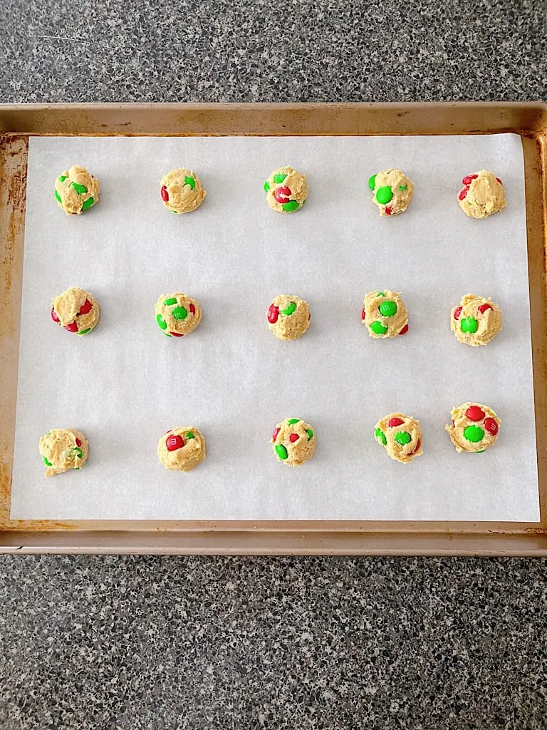 After chilling, place the cookie dough balls on a baking sheet lined with parchment paper about two inches apart.