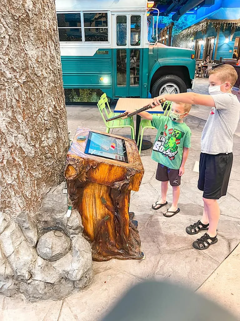 Two Kids standing in front of a MagiQuest kiosk at Great Wolf Lodge