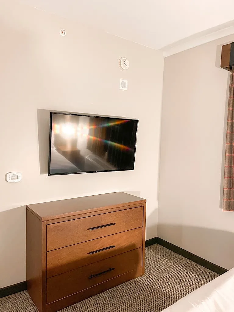 TV and dresser in Bedroom 2 of Grizzly Bear Suite