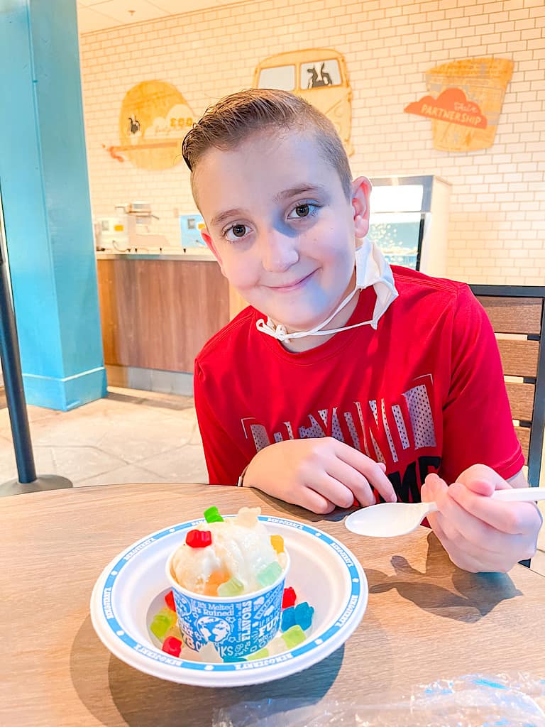 A boy with a cup of ice cream and gummy bears at Great Wolf Lodge