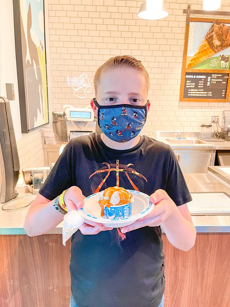 A boy with a mask holding a scoop of ice cream included with a Wolf Pass at Great Wolf Lodge