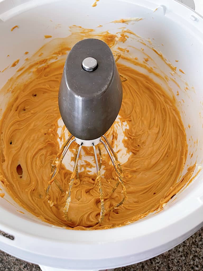 Add the softened butter and creamy peanut butter to the bowl of a stand mixer. Beat them together until light and fluffy.