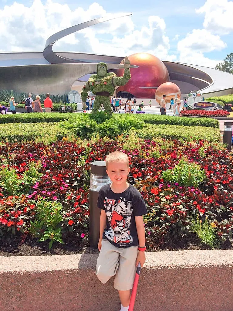 a boy in front of Buzz Lightyear made out of flowers at Epcot International Flower and Garden Festival