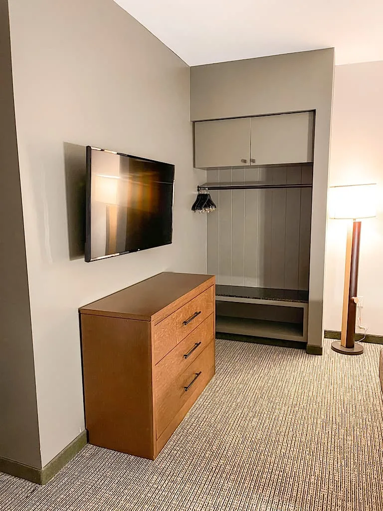 Dresser, tv, and storage area in bedroom 1 of Grizzly Bear Suite at Great Wolf Lodge Arizona