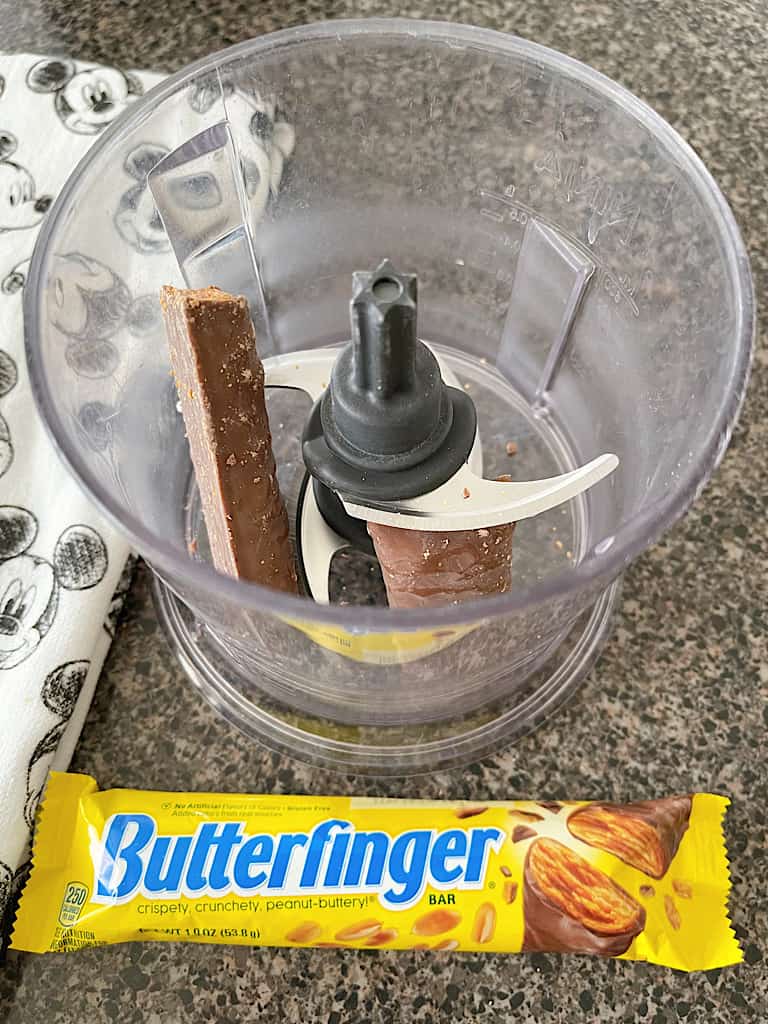 Unwrap the Butterfinger candy bars and place them in a food processor.