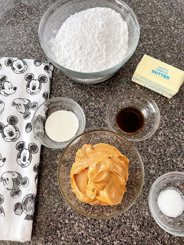 Ingredients for peanut butter frosting including powdered sugar, cream, vanilla, butter, peanut butter, and salt.