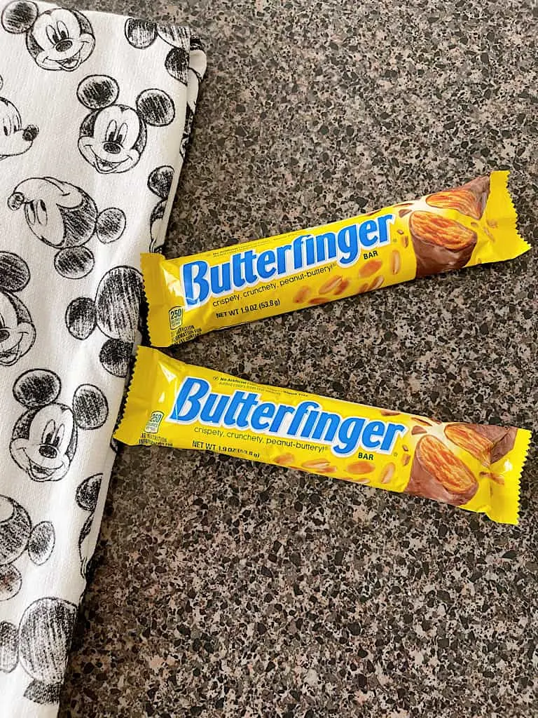 Two Butterfinger candy bars and a Mickey Mouse towel.