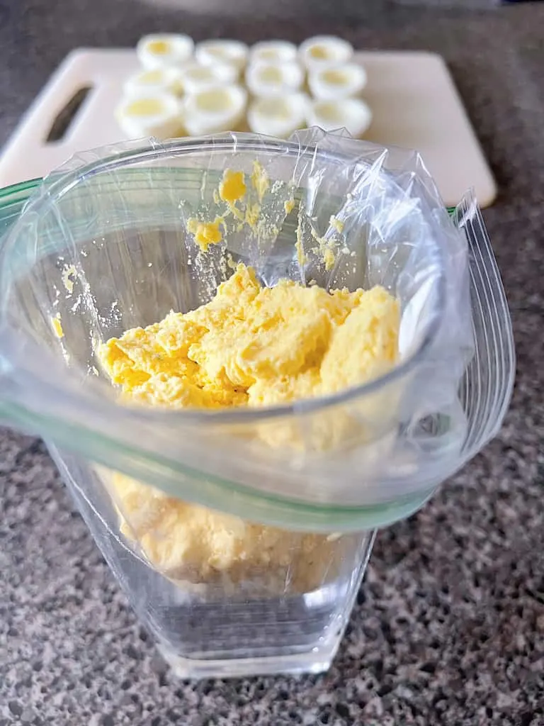 A ziplock bag filled with deviled egg yolk filling.