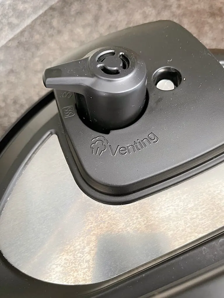 The vent closed on the lid of an Instant Pot.