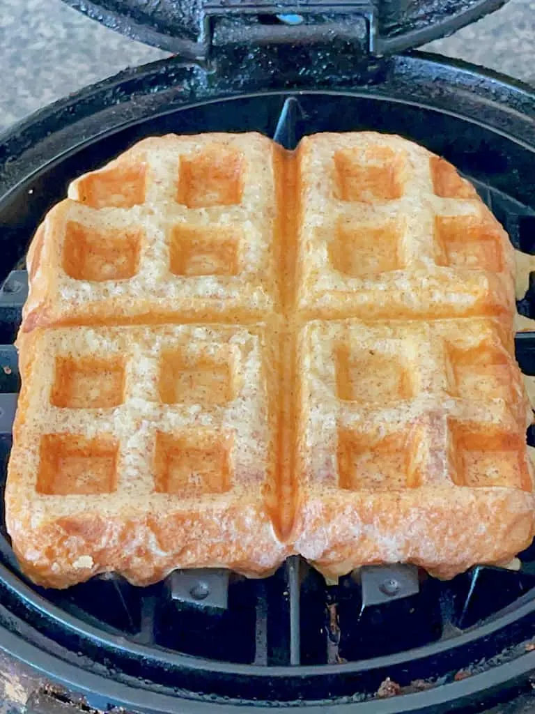 A French Toast waffle on a waffle iron.