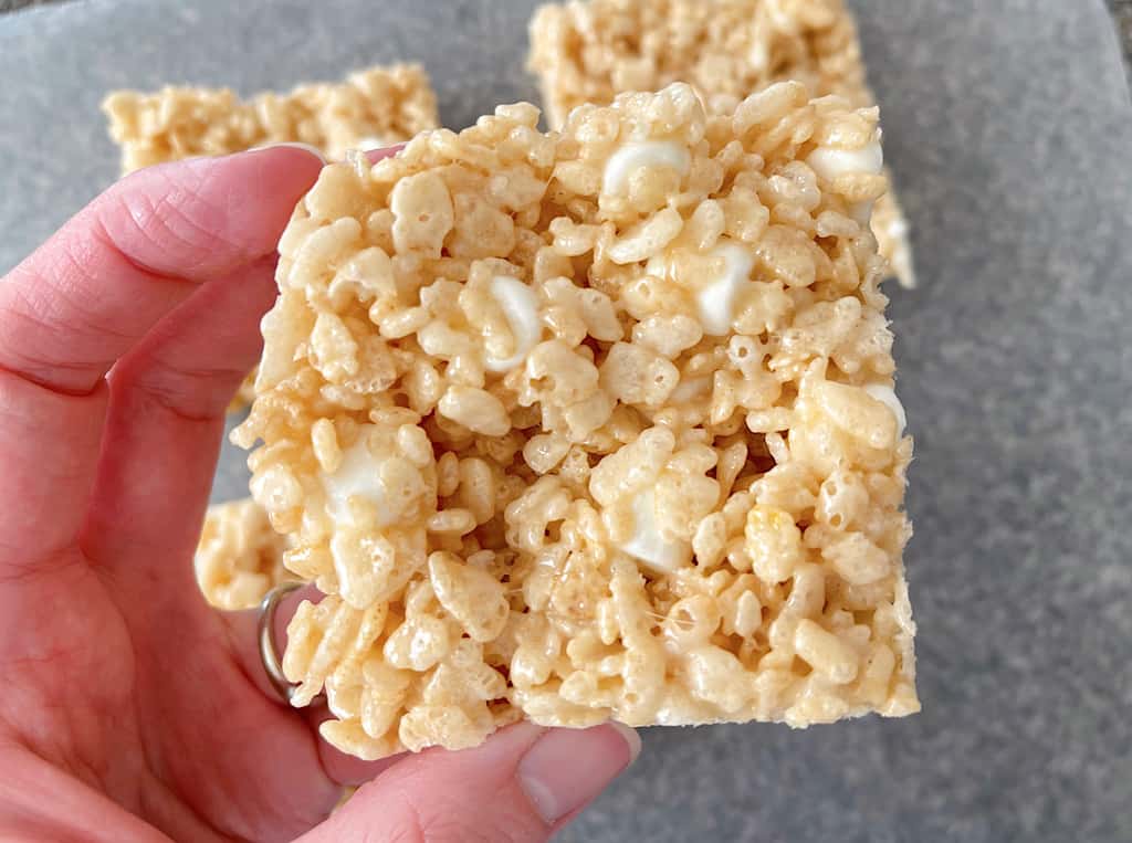 A hand holding a Rice Krispie Treat.