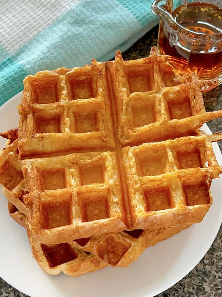French Toast waffles stacked on a white plate.