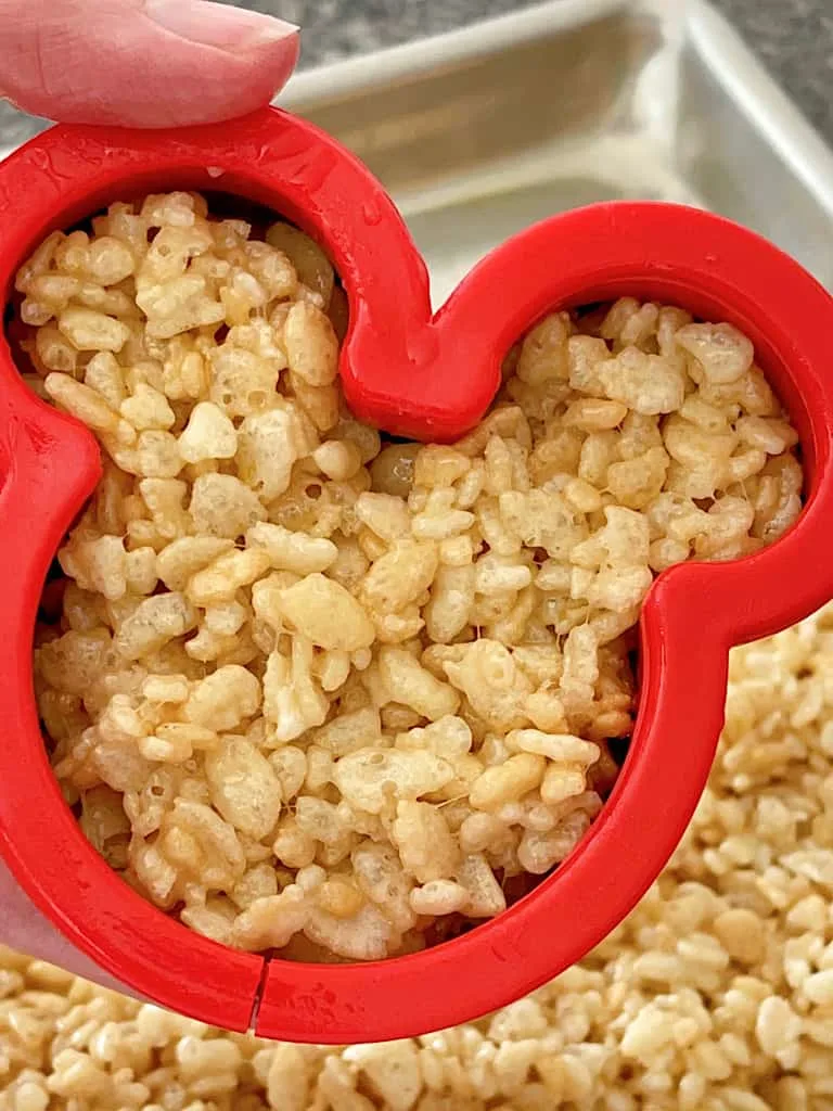 A Mickey Mouse cookie cutter filled with Rice Krispie Treat mixture.