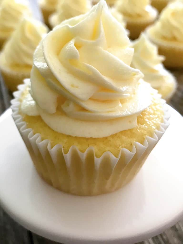 A pineapple Dole Whip Cupcake on a pedestal.