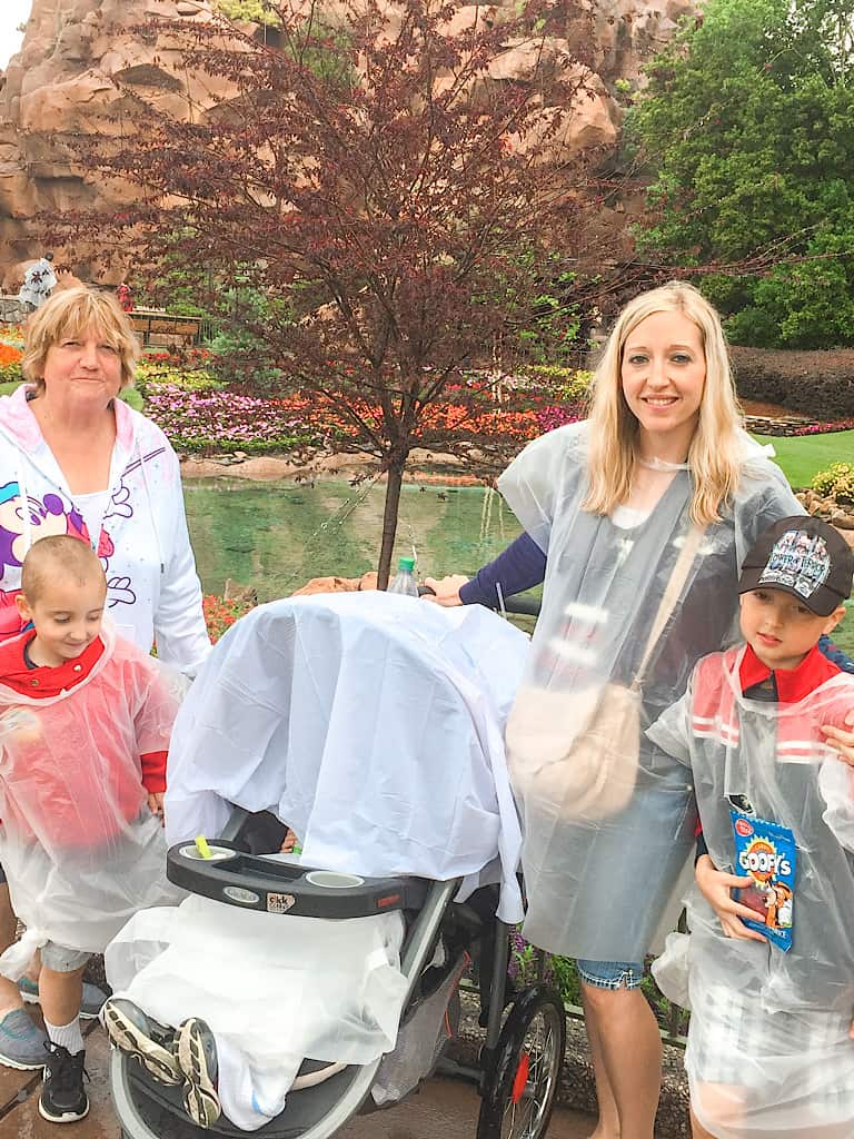 A family wearing ponchos at Epcot.