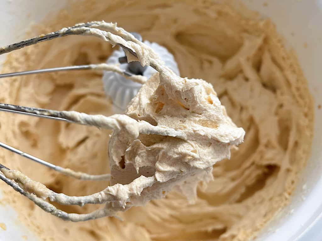 A whisk with peanut butter whipped cream.