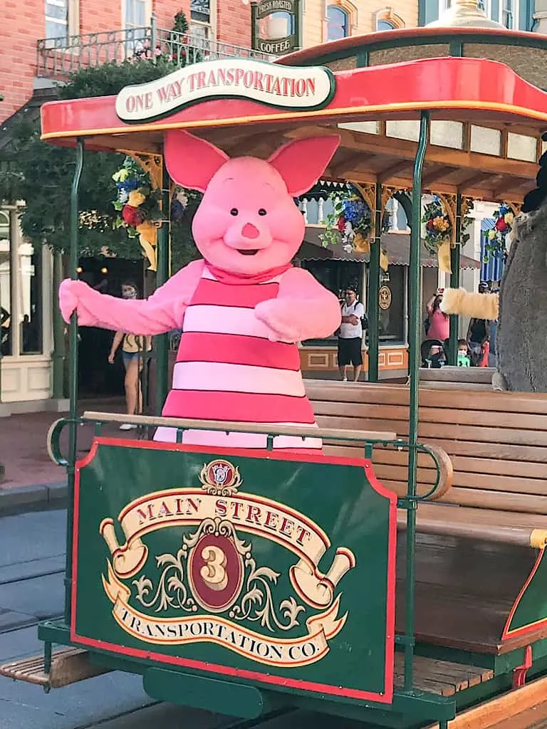 Piglet from Winnie the Pooh riding on a trolley car at Disney's Magic Kingdom.