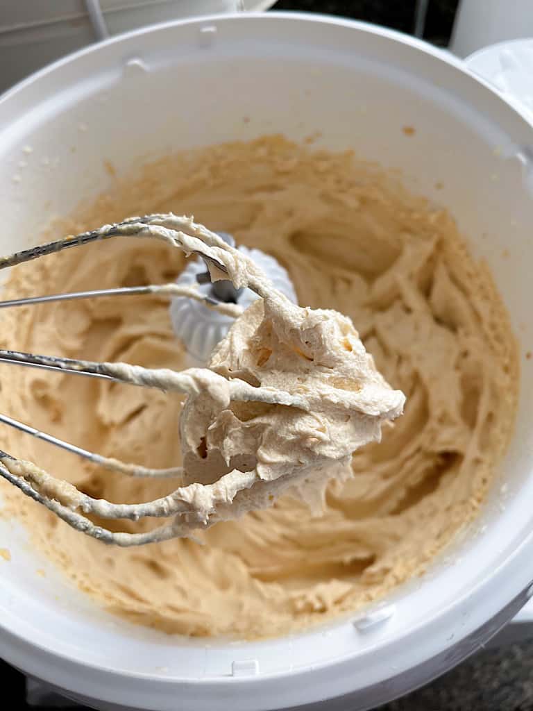 Peanut Butter Whipped Cream on a stand mixer whisk.