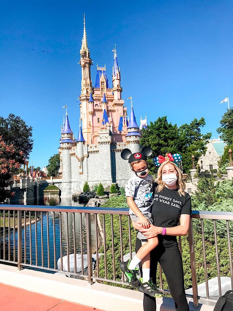 A mom and little boy in front of Cinderella Castle at Disney World.