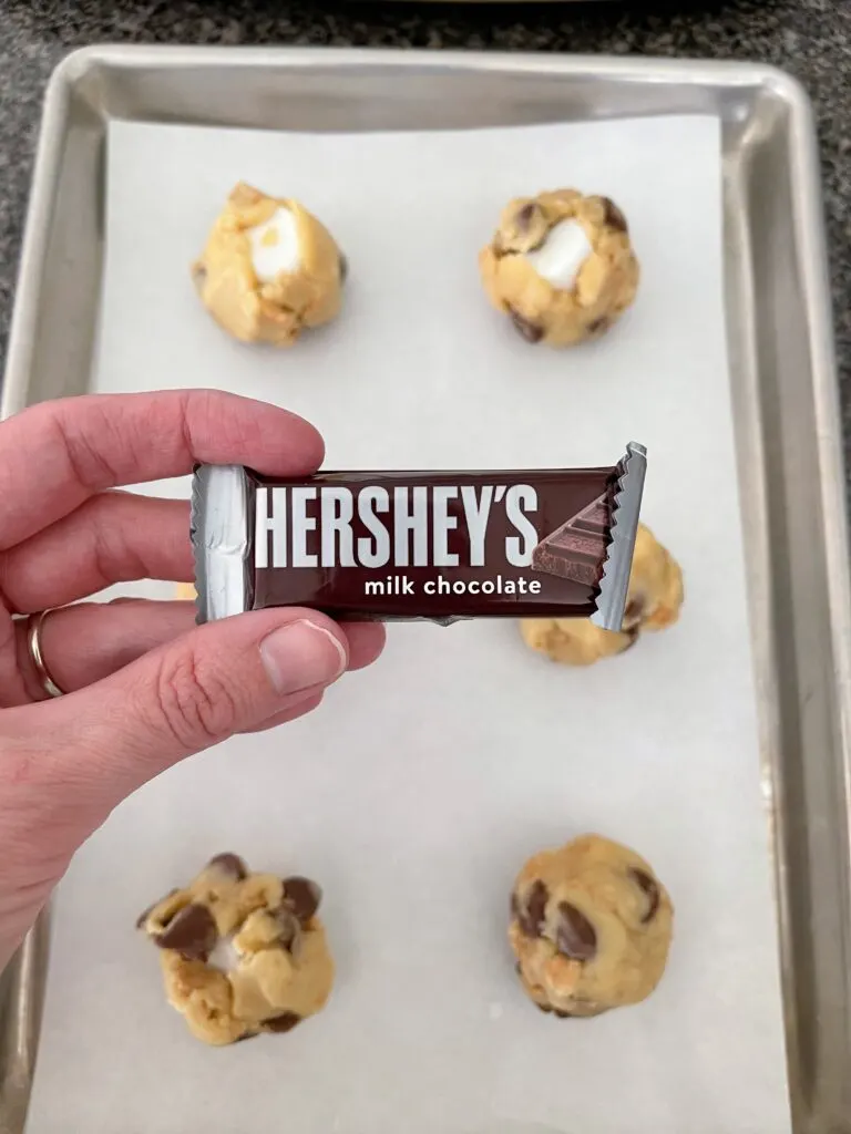 A small Hershey chocolate bar in front of S'more cookies.