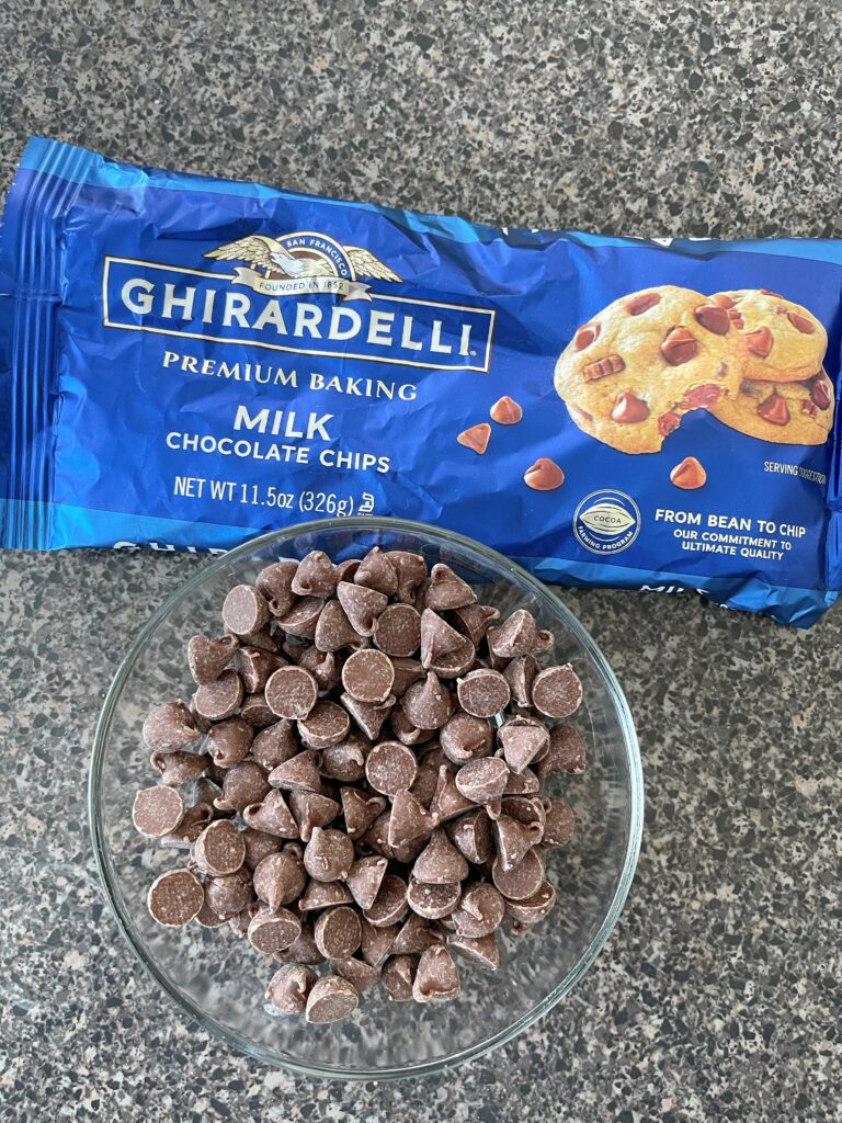 A bag of Ghirardelli chocolate chips and a bowl of chocolate chips.
