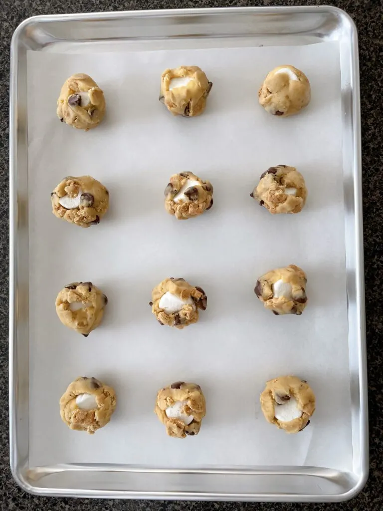 S'mores cookie dough balls on a baking sheet.