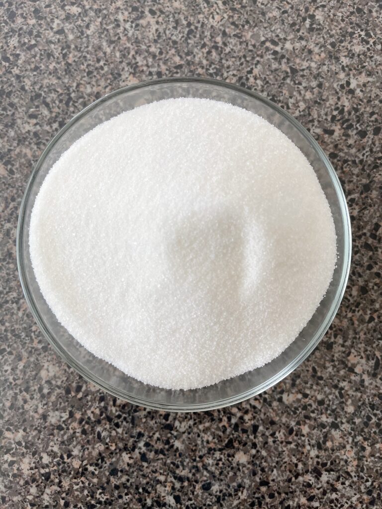 A bowl of granulated sugar.