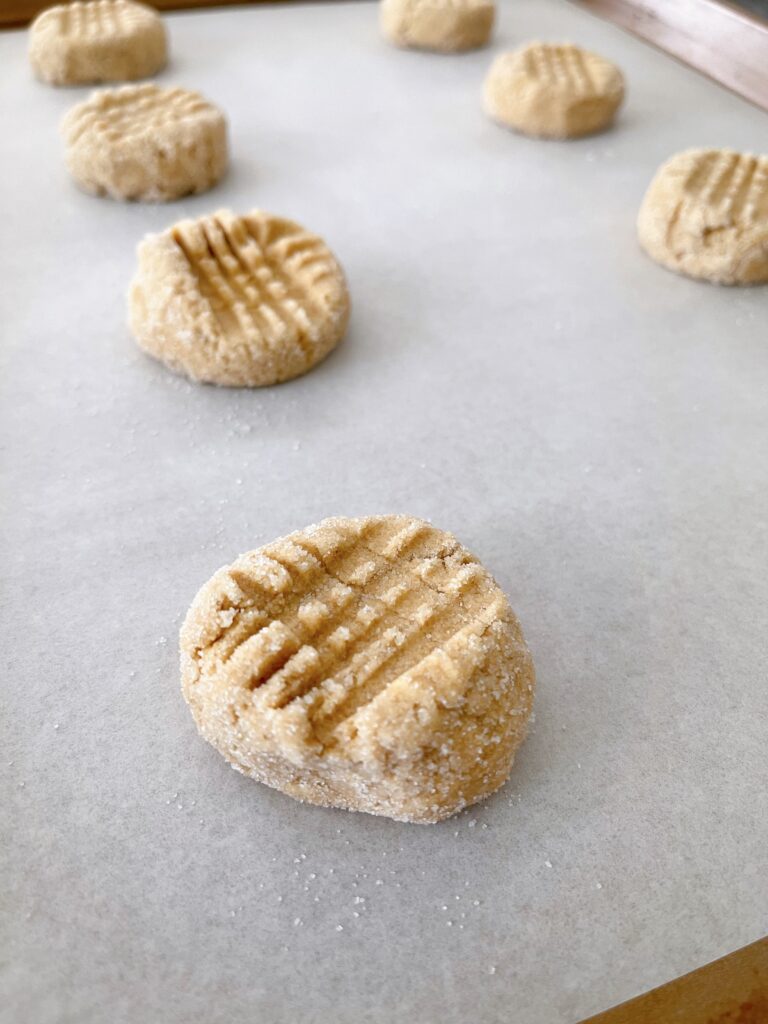 Peanut Butter cookie dough balls on a baking sheet.