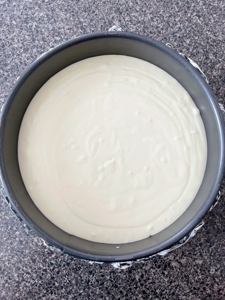 Cheesecake batter in a springform pan.