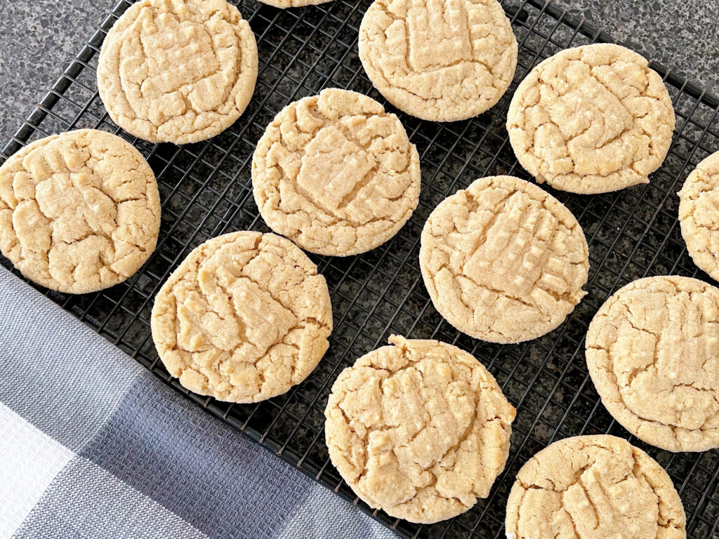 Peanut butter cookies on a cooling rack.