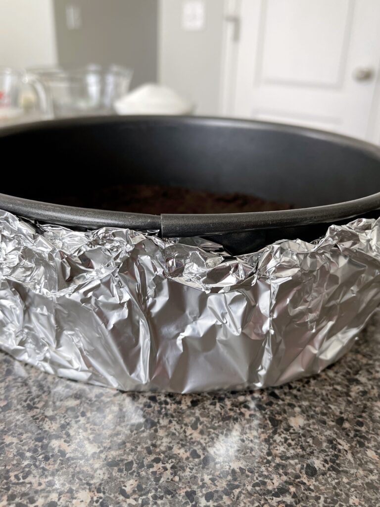A springform pan covered in foil.