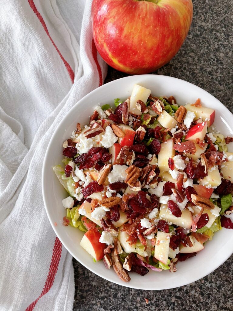 Honeycrisp apple salad with a white towel and an apple.