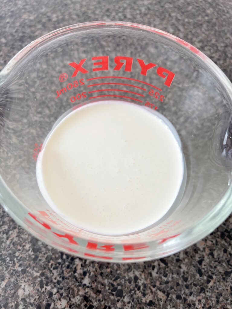 A measuring cup of heavy cream.