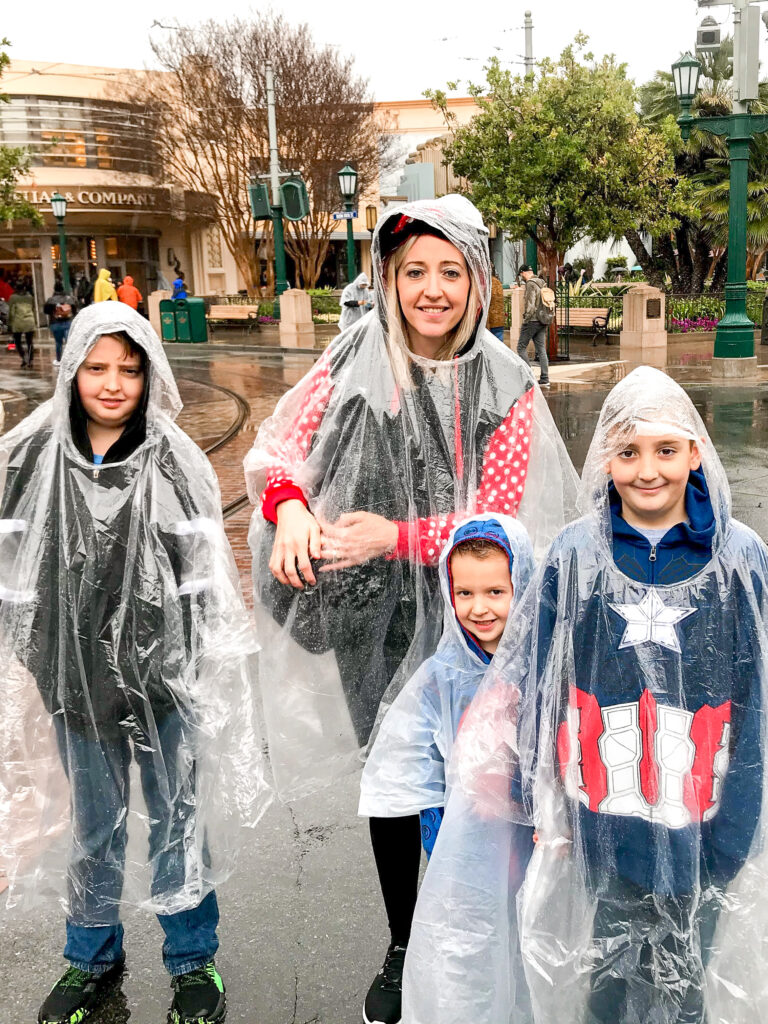 A family wearing ponchos at Disneyland.