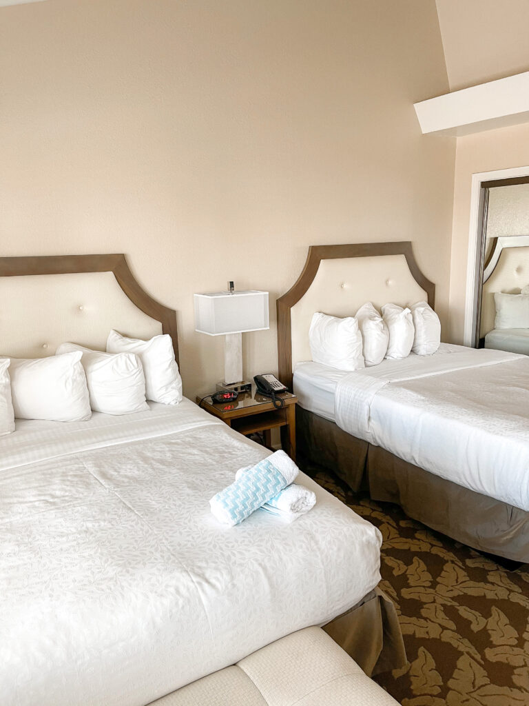 Two queen beds and a closet in Best Western Island Palms Hotel.