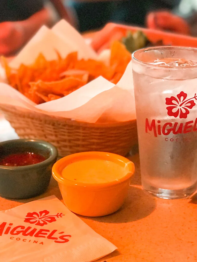 Chips, salsa, queso dip, and a glass of water at Miguel's Cocina in San Diego.