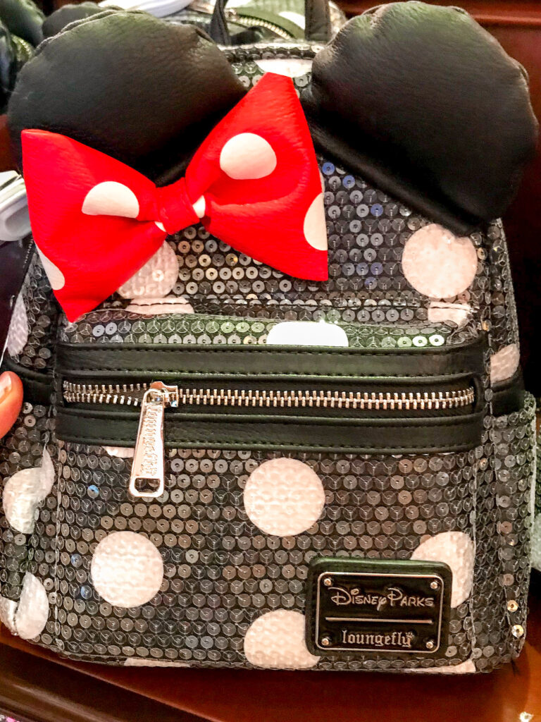 Black and white polkadot Loungefly Backpack with a red bow and mouse ears.