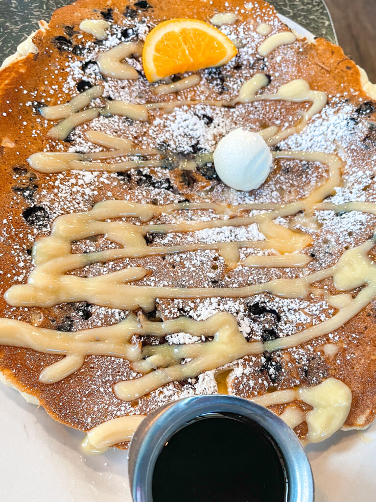 A large blueberry pancake drizzled with lemon curd from Hash House A Go Go.