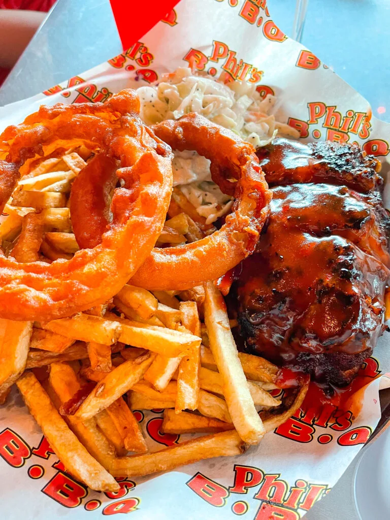 A plate of ribs, fries, and onion rings from Phil's BBQ in San Diego.