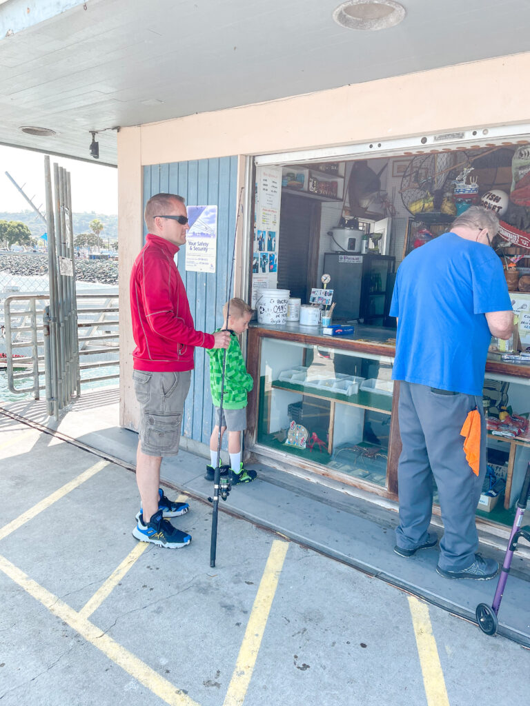 People renting fishing poles on Shelter Island pier.