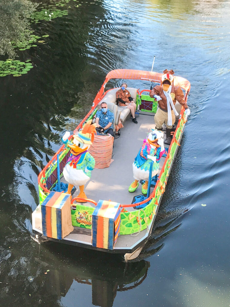 Donald Duck, Daisy Duck, and Launch Pad in a cavalcade boat at Animal Kingdom.