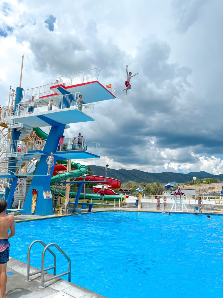 A child jumping from the top of the diving tower at Lava Hot Springs.