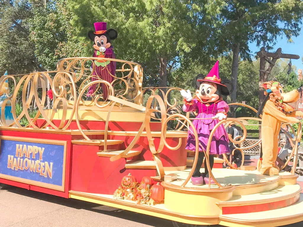 Mickey, Minnie, and Pluto on a Happy Halloween float.