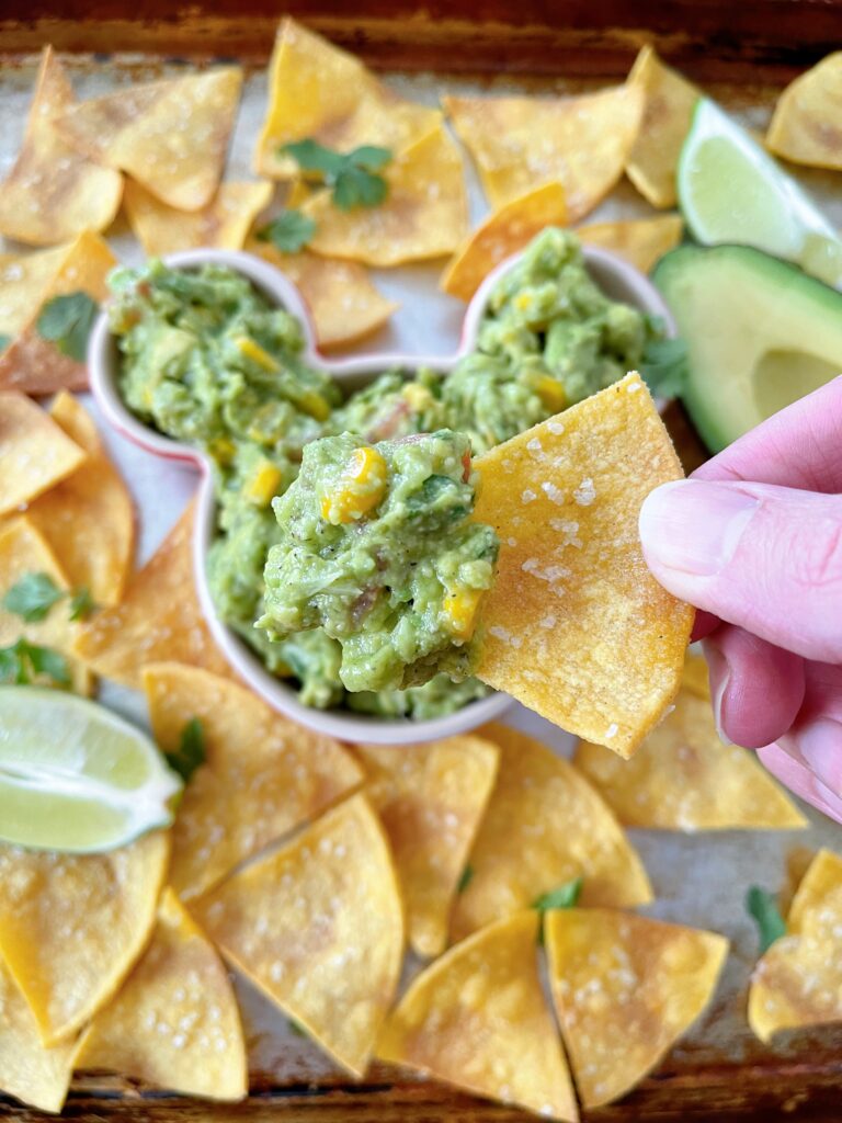 A chip topped with chunky guacamole.