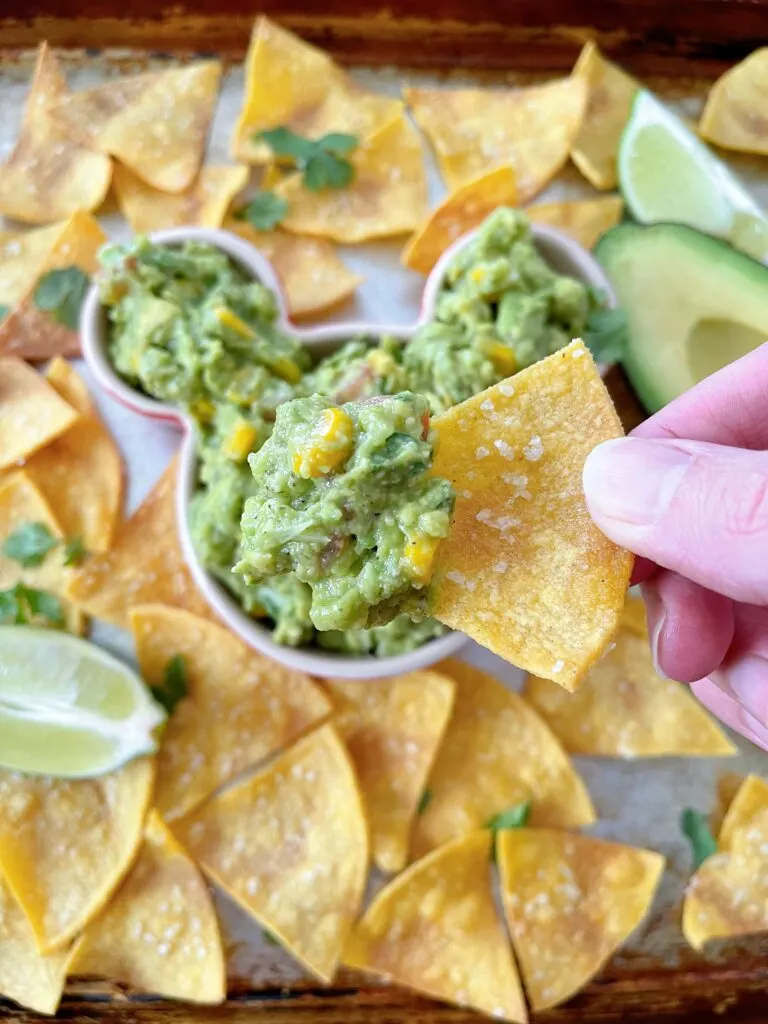 A chip topped with chunky guacamole.