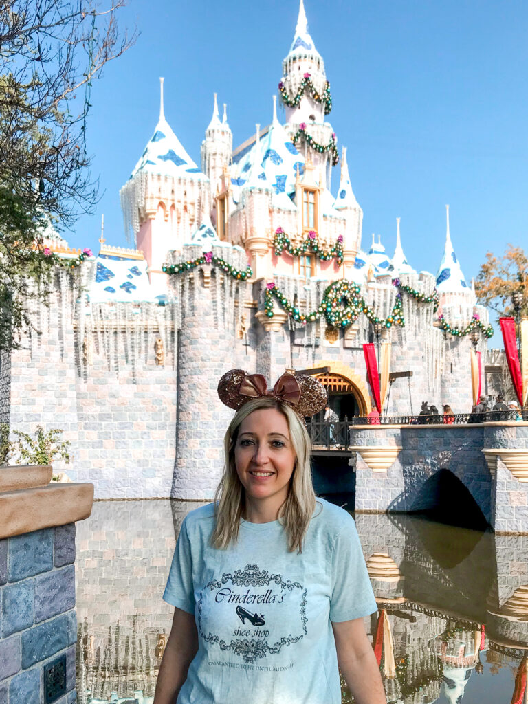 A girl in front of Sleeping Beauty Castle.