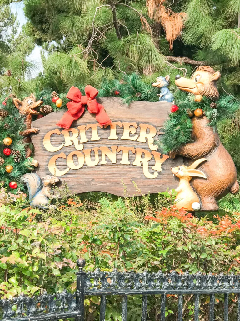 Sign for Critter Country at Disneyland decorated for Christmas.