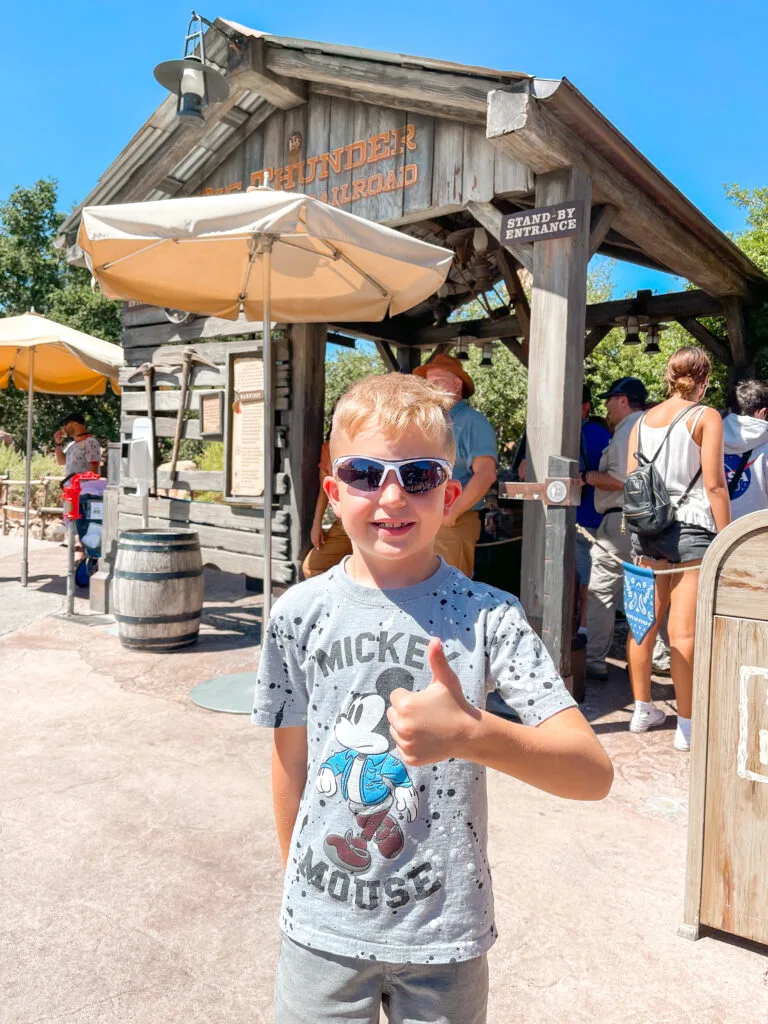 A boy in Storm Trooper sunglasses at Disneyland.