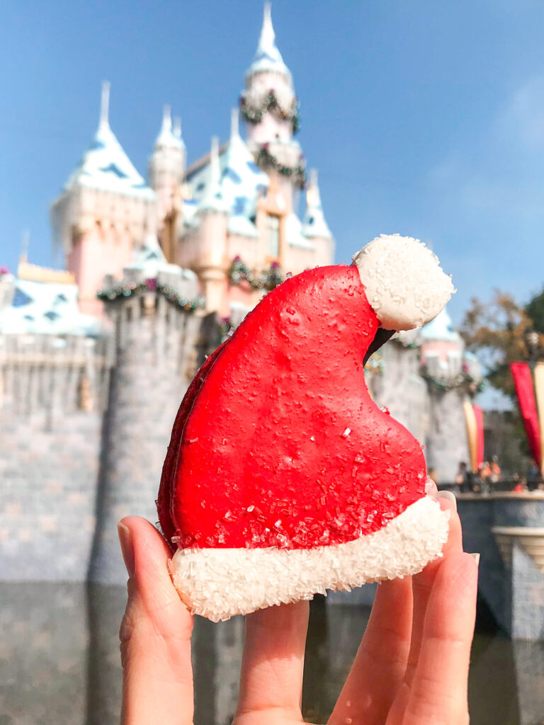 Santa Hat Macaron in front of Sleeping Beauty Castle.